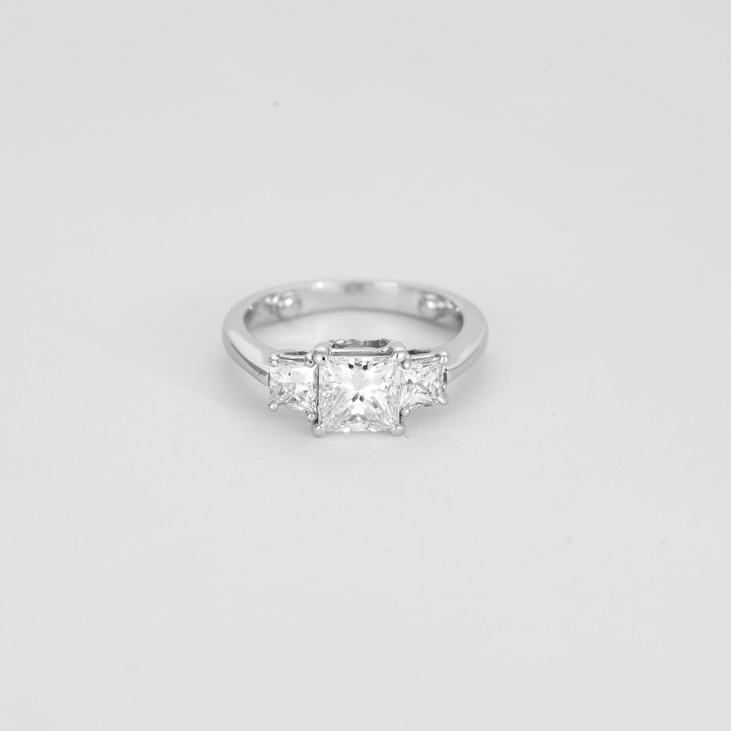 Solitaire trilogie en or blanc, 3 diamants princesse.