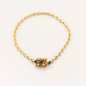 Bracelet torsadé en or jaune saphir et diamants.