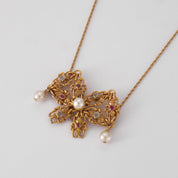 Collier Noeud en or perles, diamants et rubis